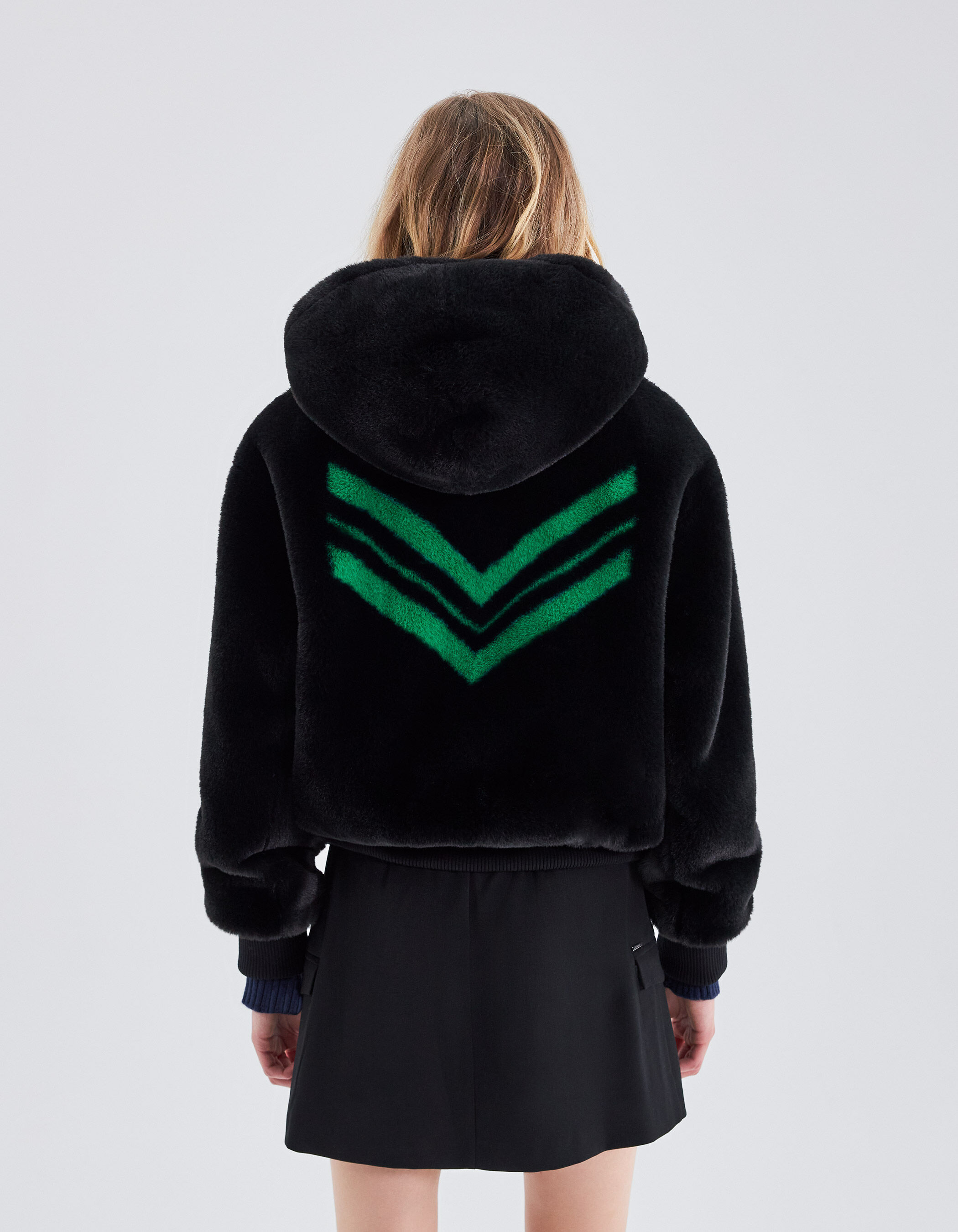 Women's black hooded jacket with green chevrons on back