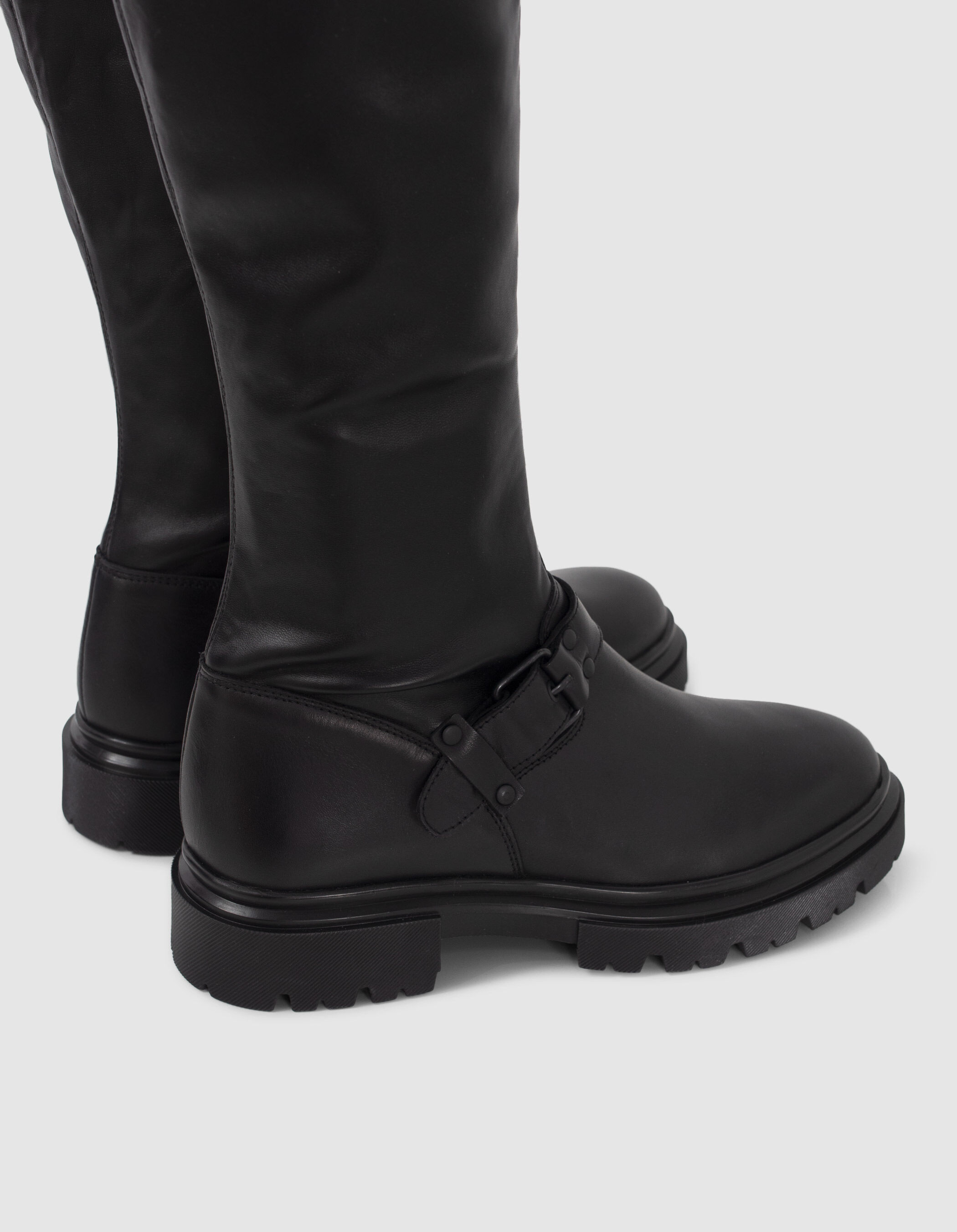 Women's black thigh-high boots with lugged soles
