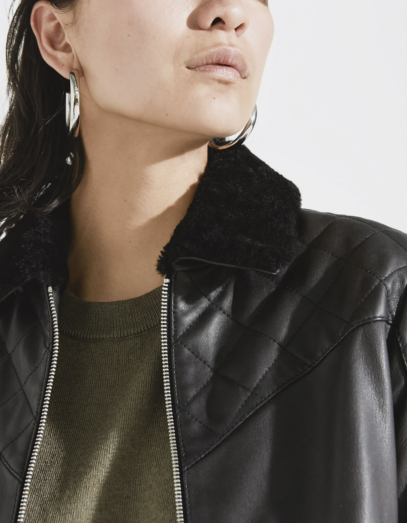 Women's black quilted leather jacket with sheepskin collar